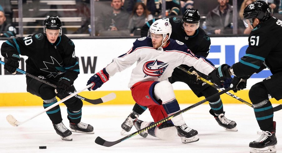 an 9, 2020; San Jose, California, USA; Columbus Blue Jackets center Alexander Wennberg (10) battles for the puck against San Jose Sharks center Antti Suomela (40) and defenseman Mario Ferraro (38) and defenseman Radim Simek (51) during the first period at SAP Center at San Jose.