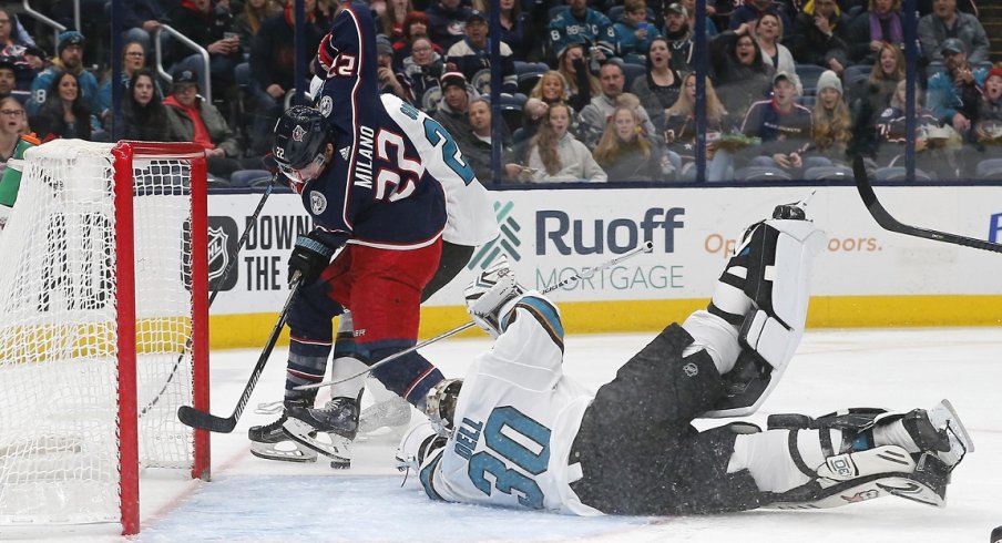  Columbus Blue Jackets left wing Sonny Milano (22) reaches for the rebound against San Jose Sharks goalie Aaron Dell (30) during the second period at Nationwide Arena.