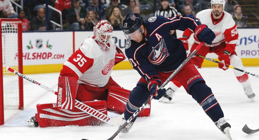 Nov 21, 2019; Columbus, OH, USA; Columbus Blue Jackets right wing Cam Atkinson (13) backhands the puck on net against the Detroit Red Wings during the second period at Nationwide Arena.