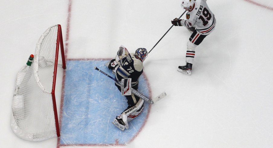 Dec 29, 2019; Columbus, Ohio, USA; Chicago Blackhawks center Jonathan Toews (19) slides the puck under Columbus Blue Jackets goalie Joonas Korpisalo (70) for goal during the shootout at Nationwide Arena. Mandatory Credit: Russell LaBounty-USA TODAY Sports