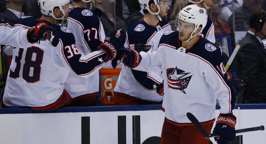 Oct 21, 2019; Toronto, Ontario, CAN; Columbus Blue Jackets forward Alexander Wennberg (10) gets congratuated after scoring the tying goal against the Toronto Maple Leafs at Scotiabank Arena. Columbus defeated Toronto in overtime. Mandatory Credit: John E. Sokolowski-USA TODAY Sports