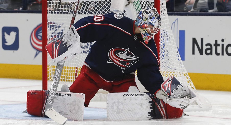 Jan 16, 2020; Columbus, Ohio, USA; Columbus Blue Jackets goalie Elvis Merzlikins (90) makes a glove save against the Carolina Hurricanes during the second period at Nationwide Arena.