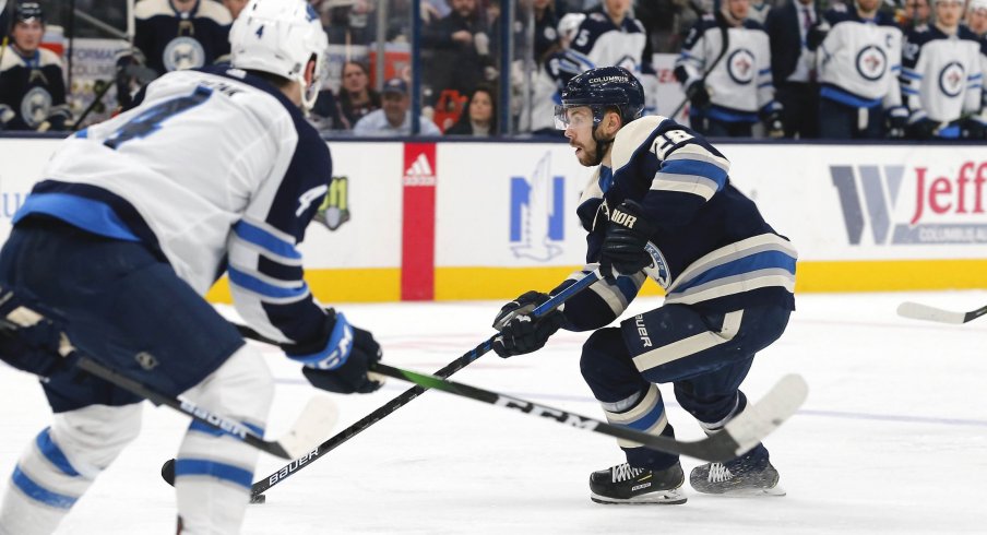 an 22, 2020; Columbus, Ohio, USA; Columbus Blue Jackets right wing Oliver Bjorkstrand (28) passes the puck against the Winnipeg Jets during the second period at Nationwide Arena.