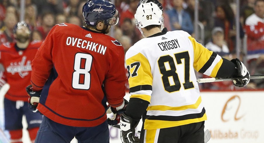 Sidney Crosby and Alex Ovechkin talk with referee Wes McCauley 