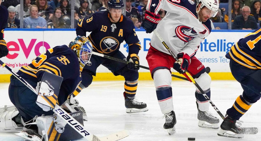 Mar 31, 2019; Buffalo, NY, USA; Columbus Blue Jackets center Boone Jenner (38) goes after a rebound in front of Buffalo Sabres goaltender Linus Ullmark (35) during the third period at KeyBank Center.