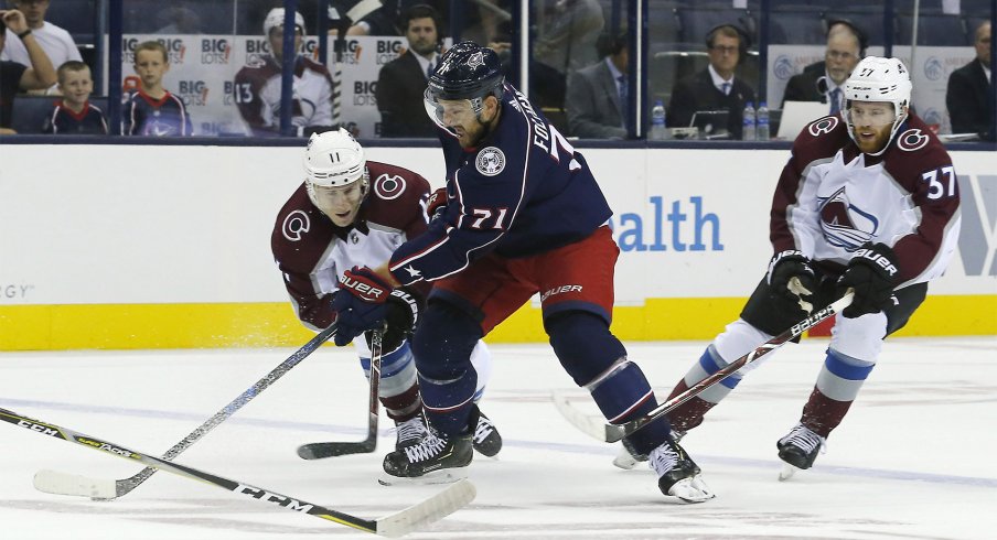 Oct 9, 2018; Columbus, OH, USA; Columbus Blue Jackets left wing Nick Foligno (71) stick handles past Colorado Avalanche left wing Matt Calvert (11) during the first period at Nationwide Arena.