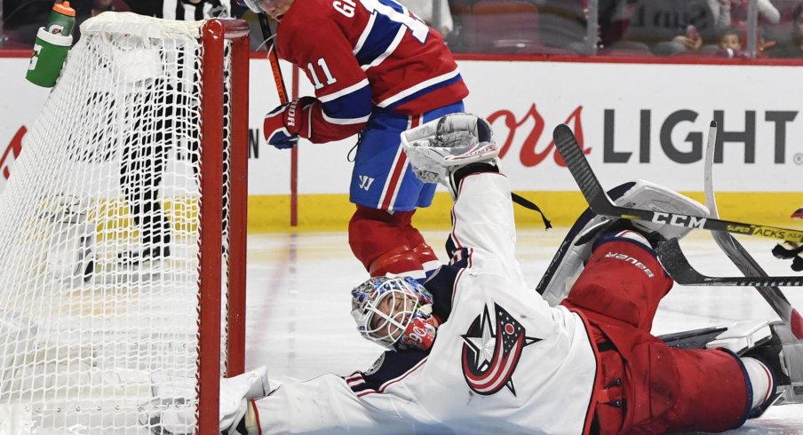 Feb 2, 2020; Montreal, Quebec, CAN; Columbus Blue Jackets goalie Elvis Merzlikins (90) makes a save against Montreal Canadiens forward Brendan Gallagher (11) during the second period at the Bell Centre.