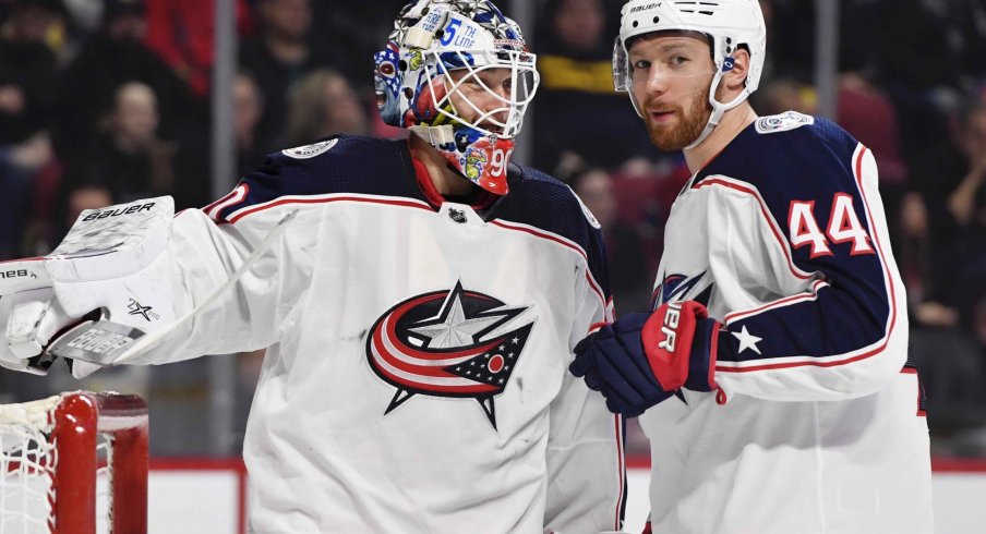 Feb 2, 2020; Montreal, Quebec, CAN; Columbus Blue Jackets goalie Elvis Merzlikins (90) and teammate Vladislav Gavrikov (44) during the second period of the game against the Montreal Canadiens at the Bell Centre. 