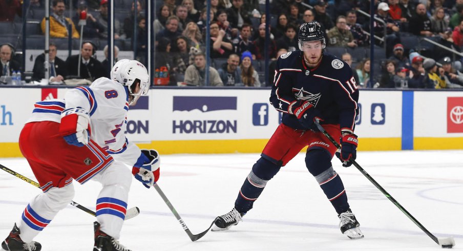 Columbus Blue Jackets center Pierre-Luc Dubois (18) passes the puck as New York Rangers defenseman Jacob Trouba (8) defends during the first period at Nationwide Arena.