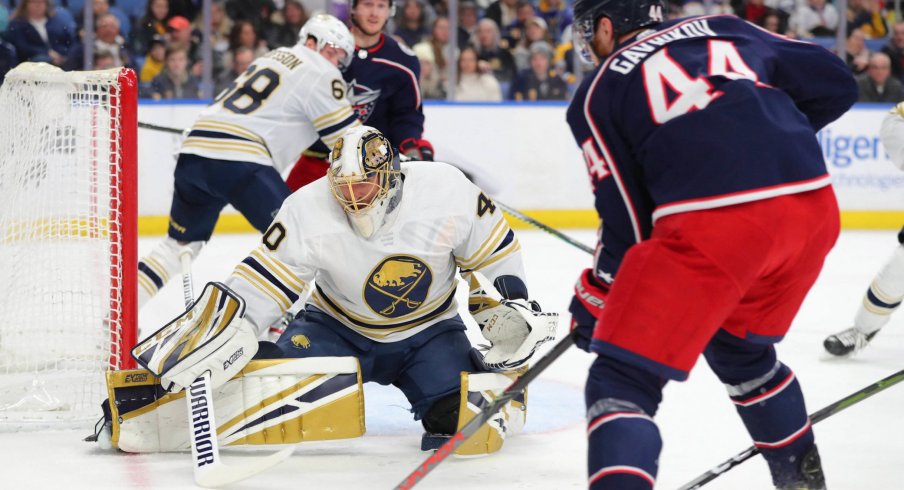 Feb 13, 2020; Buffalo, New York, USA; Buffalo Sabres goaltender Carter Hutton (40) looks to make a save on Columbus Blue Jackets defenseman Vladislav Gavrikov (44) during the first period at KeyBank Center. Mandatory Credit: Timothy T. Ludwig-USA TODAY Sports