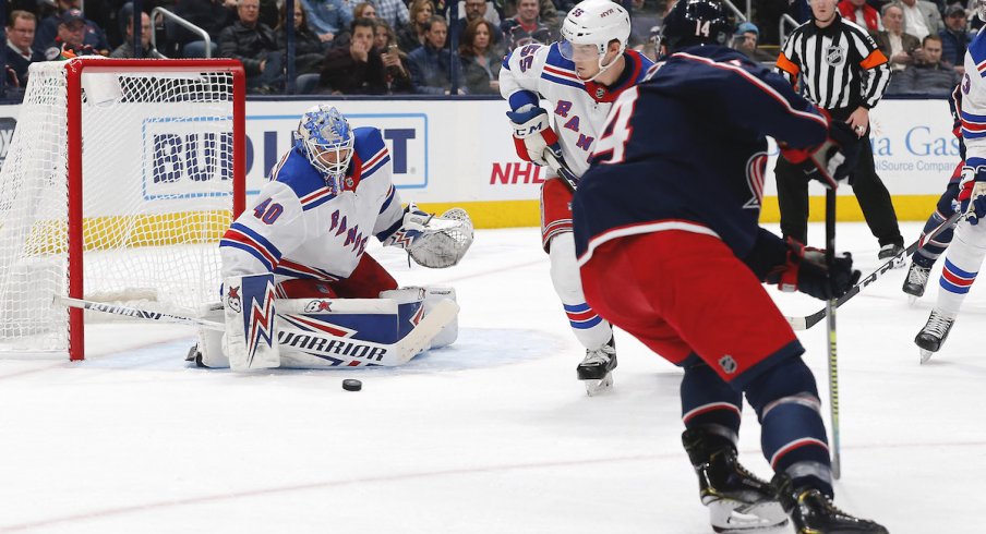 Columbus Blue Jackets forward Gustav Nyquist (14) puts the puck on goal against New York Rangers goaltender Alexandar Georgiev at Nationwide Arena.