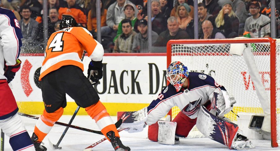 Feb 18, 2020; Philadelphia, Pennsylvania, USA; Columbus Blue Jackets goaltender Elvis Merzlikins (90) makes a save against Philadelphia Flyers center Sean Couturier (14) during the second period during the first period at Wells Fargo Center. Mandatory Credit: Eric Hartline-USA TODAY Sports