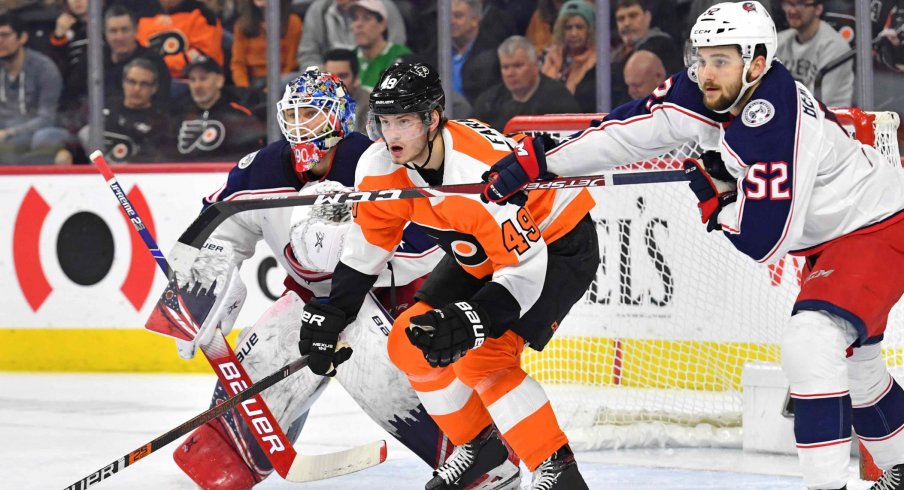 Feb 18, 2020; Philadelphia, Pennsylvania, USA; Philadelphia Flyers left wing Joel Farabee (49) fights for position with Columbus Blue Jackets center Emil Bemstrom (52) in front of goaltender Elvis Merzlikins (90) during the second period during the first period at Wells Fargo Center.