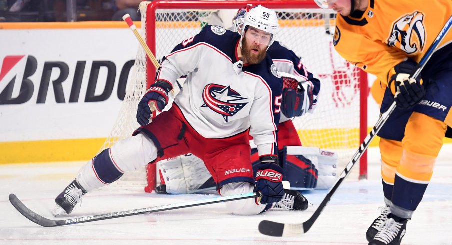 Mar 30, 2019; Nashville, TN, USA; Columbus Blue Jackets defenseman David Savard (58) drops to the ice to defend a shot from Nashville Predators center Ryan Johansen (92) during the second period at Bridgestone Arena.