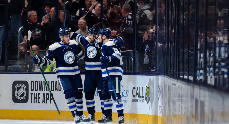 Columbus Blue Jackets left wing Nick Foligno (middle) celebrates with teammate center Pierre-Luc Dubois (left) and right wing Oliver Bjorkstrand (right) after scoring a goal against the Philadelphia Flyers in the first period at Nationwide Arena.