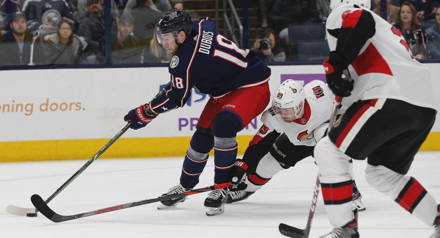 Nov 25, 2019; Columbus, OH, USA; Columbus Blue Jackets center Pierre-Luc Dubois (18) carries the puck as Ottawa Senators right wing Mikkel Boedker (89) tries to poke check during the second period at Nationwide Arena.