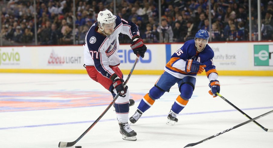 Nov 30, 2019; Brooklyn, NY, USA; Columbus Blue Jackets right wing Josh Anderson (77) shoots against New York Islanders right wing Cal Clutterbuck (15) during the third period at Barclays Center.