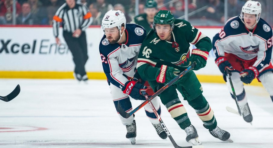 Feb 25, 2020; Saint Paul, Minnesota, USA; Minnesota Wild defenseman Jared Spurgeon (46) and Columbus Blue Jackets forward Emil Bemstrom (52) skate after the puck in the first period at Xcel Energy Center.