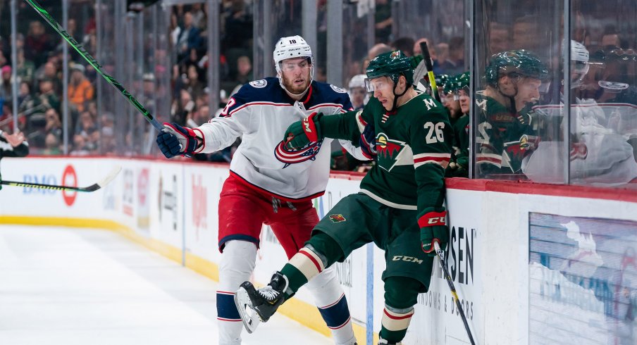 Feb 25, 2020; Saint Paul, Minnesota, USA; Columbus Blue Jackets forward Pierre-Luc Dubois (18) checks Minnesota Wild forward Gerald Mayhew (26) in the second period at Xcel Energy Center.