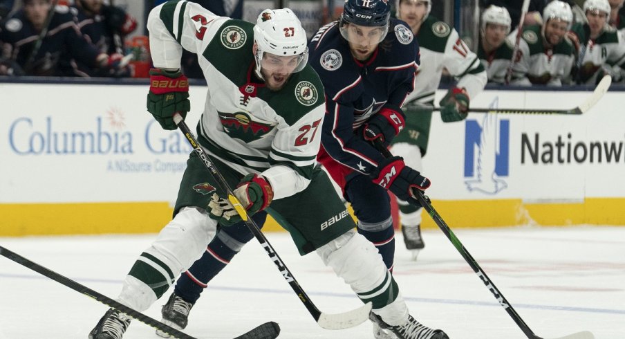 Alex Galchenyuk and Kevin Stenlund battle for the puck