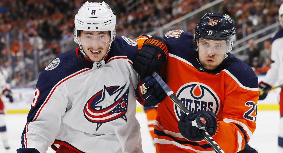 Mar 21, 2019; Edmonton, Alberta, CAN; Columbus Blue Jackets defensemen Zack Werenski (8) and Edmonton Oilers forward Leon Draisaitl (29) battle for position during the third period at Rogers Place.