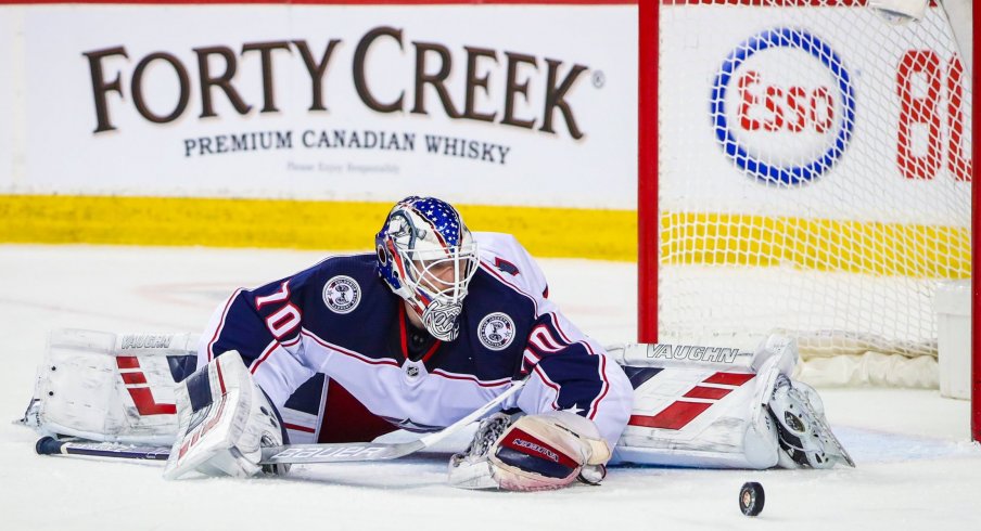 Columbus Blue Jackets goaltender Joonas Korpisalo (70) makes a save against the Calgary Flames during the third period at Scotiabank Saddledome.