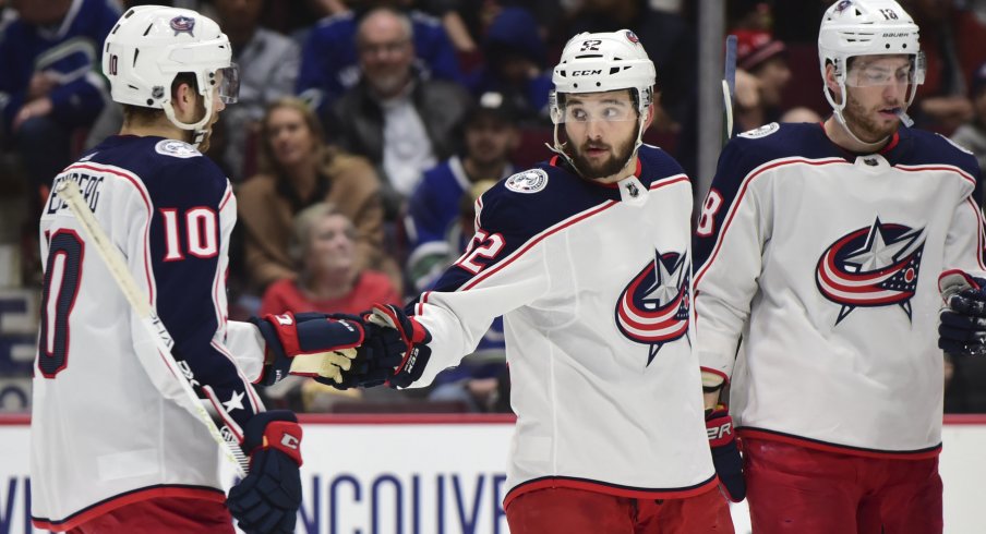 Mar 8, 2020; Vancouver, British Columbia, CAN; Columbus Blue Jackets forward Emil Bemstrom (52) celebrates his goal against Vancouver Canucks goaltender Thatcher Demko (35) (not pictured) with Columbus Blue Jackets forward Alexander Wennberg (10) during the second period at Rogers Arena. Mandatory Credit: Anne-Marie Sorvin-USA TODAY Sports