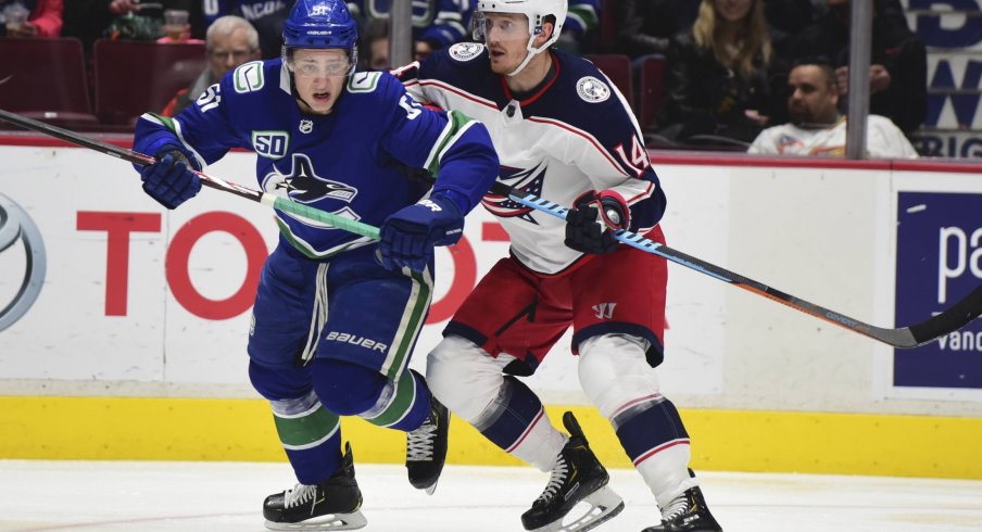 Mar 8, 2020; Vancouver, British Columbia, CAN; Vancouver Canucks defenseman Troy Stecher (51) skates against Columbus Blue Jackets forward Gustav Nyquist (14) during the second period at Rogers Arena.