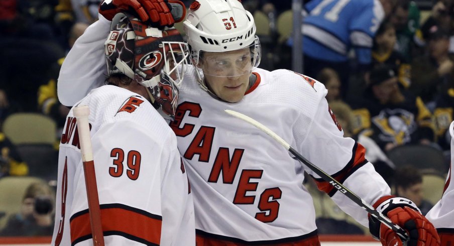 Carolina Hurricanes goaltender Alex Nedeljkovic (39) and defenseman Jake Gardiner (51) celebrate after defeating the Pittsburgh Penguins at PPG PAINTS Arena. The Hurricanes won 6-2.