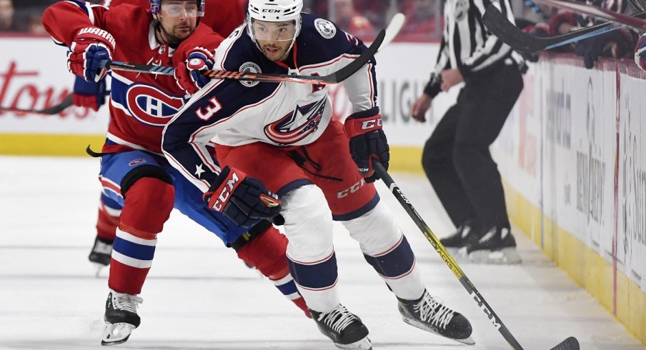 Seth Jones skates down the wall, as Tomas Tatar attempts to slow down his progress.