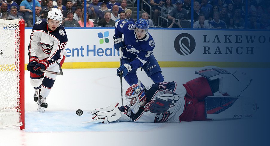 Columbus Blue Jackets goaltender Sergei Bobrovsky reaches for a puck as Yanni Gourde of the Tampa Bay Lightning approaches during Game 1 at Amalie Arena.