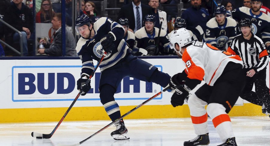 Caption: Nov 27, 2019; Columbus, OH, USA; Columbus Blue Jackets right wing Josh Anderson (77) wrists a shot on goal as Philadelphia Flyers defenseman Ivan Provorov (9) defends during the second period at Nationwide Arena.