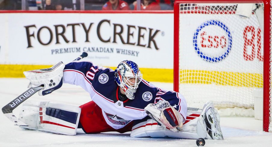 Columbus Blue Jackets goaltender Joonas Korpisalo (70) makes a save against the Calgary Flames during the third period at Scotiabank Saddledome.