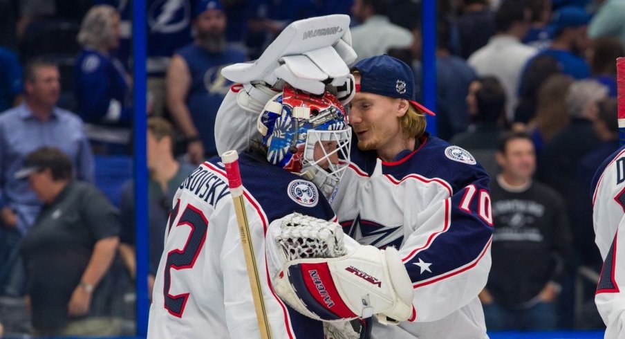 Korpisalo and Merzlikins celebrate after a win