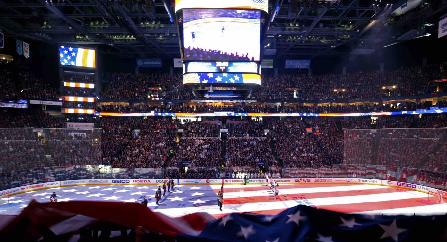 A view of the Tampa Bay Lightning and the Columbus Blue Jackets starters as an American flag is passed over the crowd during the national anthem prior to game three of the first round of the 2019 Stanley Cup Playoffs at Nationwide Arena.