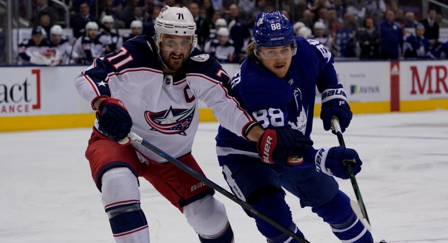Columbus Blue Jackets forward Nick Foligno (71) and Toronto Maple Leafs forward William Nylander (88) battle for position at Scotiabank Arena. Columbus defeated Toronto in overtime.
