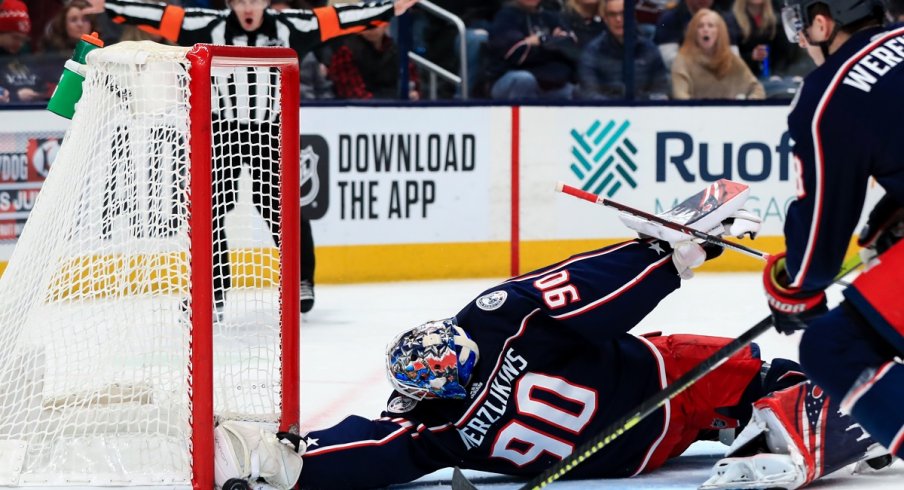 Elvis Merzlikins dives to make a save 