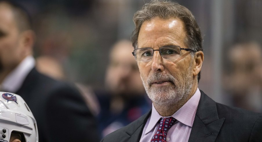 John Tortorella looks on from behind the bench