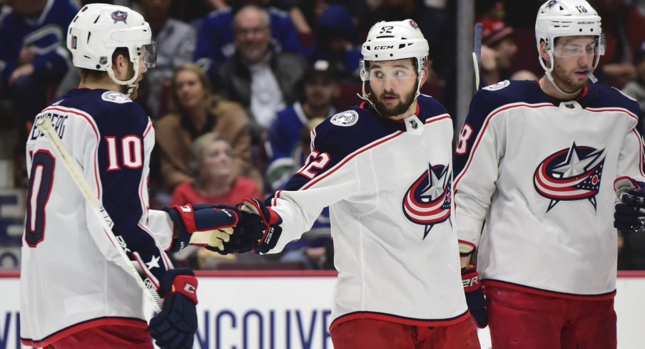 Mar 8, 2020; Vancouver, British Columbia, CAN; Columbus Blue Jackets forward Emil Bemstrom (52) celebrates his goal against Vancouver Canucks goaltender Thatcher Demko (35) (not pictured) with Columbus Blue Jackets forward Alexander Wennberg (10) during the second period at Rogers Arena.