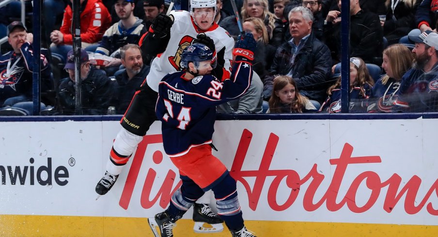 Nathan Gerbe checks Mike Reilly at Nationwide Arena.