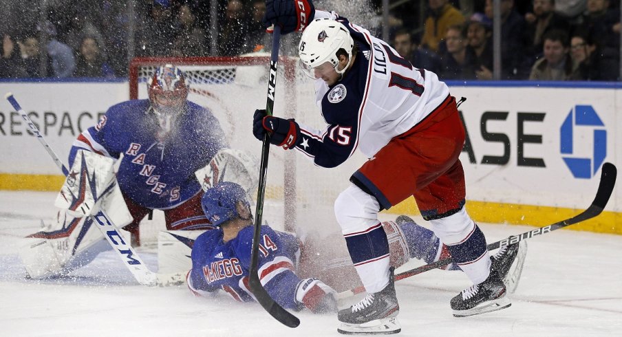 Jakob Lilja of the Columbus Blue Jackets controls the puck in front of the New York Rangers net.