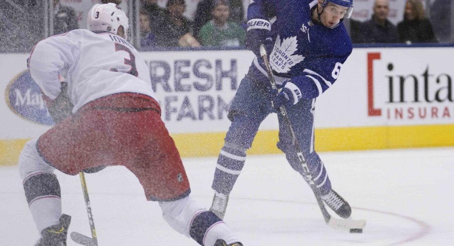 Toronto Maple Leafs forward Ilya Mikheyev (65) shoots the puck against Columbus Blue Jackets defenseman Seth Jones (3) at Scotiabank Arena. Columbus defeated Toronto in overtime.