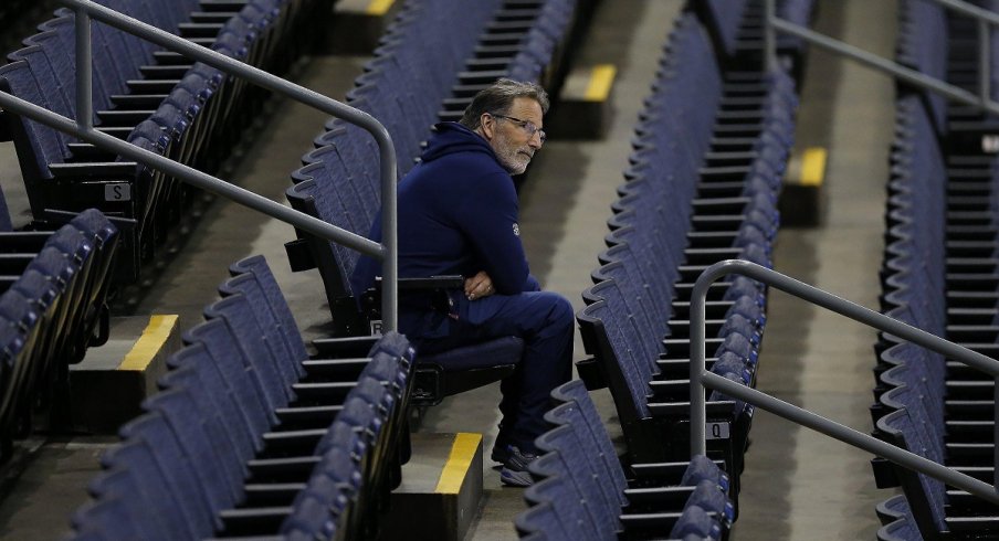 John Tortorella watches his team practice from the stands