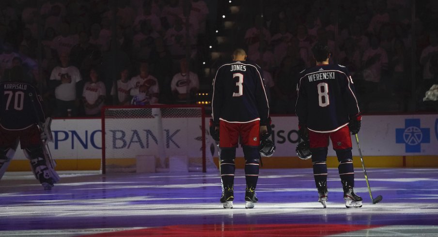 Columbus Blue Jackets defenseman Zach Werenski (8) and Columbus Blue Jackets defenseman Seth Jones (3) looks on during the National Athem before the game against the Carolina Hurricanes at PNC Arena. 