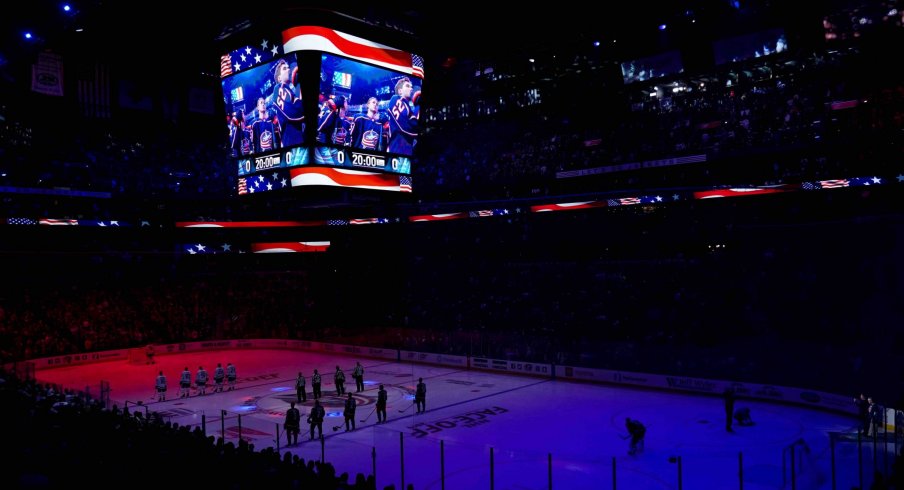 The starters for the Toronto Maple Leafs and the Columbus Blue Jackets stand on the ice for the American National Anthem prior to the game at Nationwide Arena.