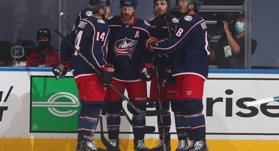 Boone Jenner #38 of the Columbus Blue Jackets celebrates with teammates after Jenner scored during the first period of an exhibition game against the Boston Bruins prior to the 2020 NHL Stanley Cup Playoffs at Scotiabank Arena on July 30, 2020 in Toronto, Ontario.