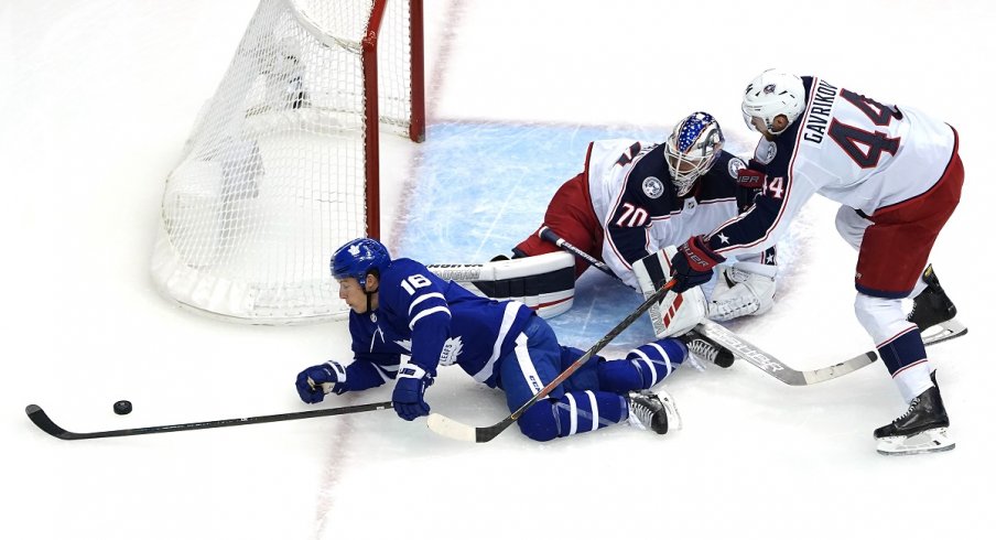 Vladislav Gavrikov keeps the puck out harm's way 