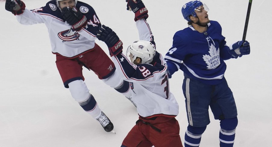 Aug 9, 2020; Toronto, Ontario, CAN; Columbus Blue Jackets forward Gustav Nyquist (14) and forward Boone Jenner (38)celebrate a goal by Columbus Blue Jackets defenseman Zach Werenski (not pictured) as Toronto Maple Leafs defenseman Tyson Barrie (94) skates away during the first period of game five of the Eastern Conference qualifications at Scotiabank Arena.