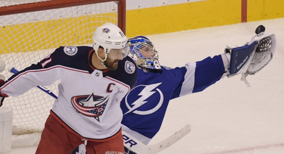 Tampa Bay Lightning goaltender Andrei Vasilevskiy (88) makes a save behind Columbus Blue Jackets left wing Nick Foligno (71) in the third overtime in game one of the first round of the 2020 Stanley Cup Playoffs at Scotiabank Arena.