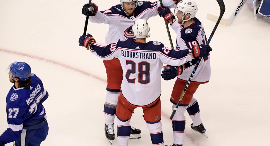 Aug 13, 2020; Toronto, Ontario, CAN; Columbus Blue Jackets right wing Oliver Bjorkstrand (28) celebrates his goal against the Tampa Bay Lightning with teammates during the first period in game two of the first round of the 2020 Stanley Cup Playoffs at Scotiabank Arena.